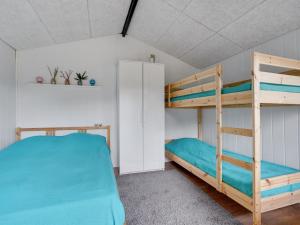 a bunk bed room with two bunk beds at Holiday Home Edith - 1km from the sea by Interhome in Hals