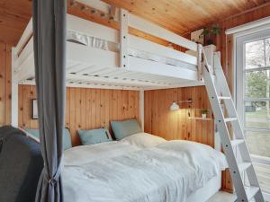 a bedroom with a bunk bed and a ladder at Holiday Home Imma - from the sea in NE Jutland by Interhome in Hals