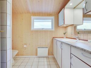 a bathroom with a sink and a toilet at Holiday Home Jussi - 3-5km from the sea in NW Jutland by Interhome in Brovst
