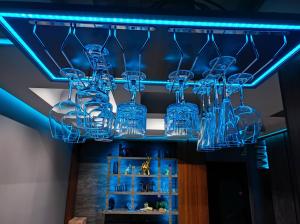 a chandelier hanging from a ceiling with blue lights at Smart Luxury Penthouse Suites - Private Sauna, Hot-Tub, Home Cinema at the best Location in Skopje in Skopje