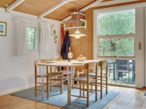 a dining room with a table and chairs at Holiday Home Herdina - 4km from the sea in NW Jutland by Interhome in Brovst