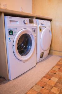 a washer and dryer sitting under a counter at STUNNING 3 Double Bedroom Apartment - *Town Centre / Near Beach* in Berwick-Upon-Tweed