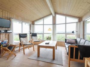 ein Wohnzimmer mit einem Sofa und einem Tisch in der Unterkunft Holiday Home Fanija - 200m from the sea in NW Jutland by Interhome in Hjørring