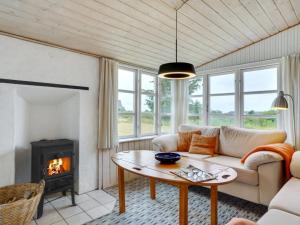 un soggiorno con divano e camino di Holiday Home Githa - 100m to the inlet in The Liim Fiord by Interhome a Løgstør