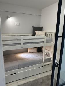 two bunk beds in a small room at ALTAMIRA FAMILY APARTMENT El Duque in Adeje