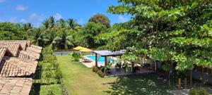 an image of a backyard with a swimming pool at Vila Sol Chalés in Pôrto de Pedras