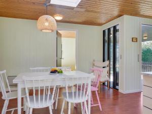 a dining room with a white table and chairs at Holiday Home Ludde - 500m to the inlet in The Liim Fiord by Interhome in Løgstør