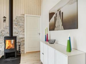een open haard in een woonkamer met een bakstenen muur bij Holiday Home Anethe - 100m to the inlet in The Liim Fiord by Interhome in Løgstør