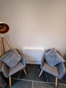 two chairs with blankets on them in a room at The Den - A modern, quirky room, new for 2023. in Braunton