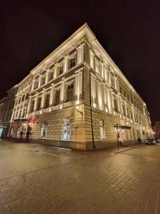 a large building on a street at night at Grand Hotel in Krakow