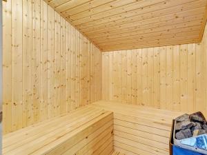 a wooden sauna with a wood paneled wall at Holiday Home Arkil - 300m from the sea in NW Jutland by Interhome in Hjørring