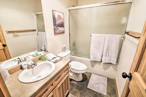 a bathroom with a sink and a toilet and a shower at Chalet at Running Y Resort w/ Wraparound Deck! in Klamath Falls +25 photos