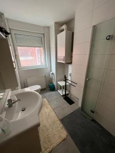 a bathroom with a sink and a toilet at Ferienwohnung Sandmann in Greifswald