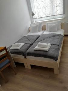 a bedroom with two beds with towels on them at Apartamencik Perełka in Skoczów