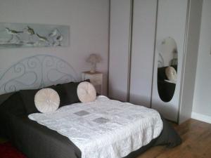 a bedroom with a bed with two pillows on it at Les Blancarts in Hautebut