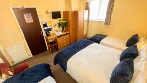 Postel nebo postele na pokoji v ubytování Sutcliffe Hotel