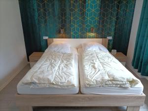 Ein Bett oder Betten in einem Zimmer der Unterkunft Landhaus Dahlem