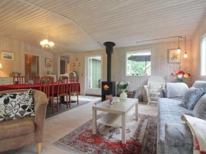 a living room with a couch and a table at Holiday Home Elmer - 400m from the sea in NE Jutland by Interhome in Jerup