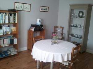 Les Blancarts في Hautebut: غرفة مع طاولة مع إناء من الزهور عليها