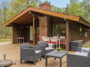 a pavilion with a table and chairs on a deck at Holiday Home Thorger - 3km from the sea in NE Jutland by Interhome in Læsø