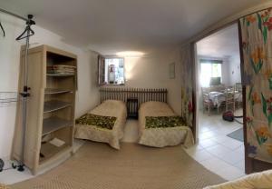 a living room with two beds and a table at Les Nympheas, appart au calme et grand jardin à 15 min de Disneyland, in Crécy-la-Chapelle