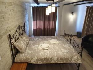 a bedroom with a bed with two pillows on it at Rooms Poienita in Slănic-Moldova