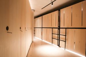a row of lockers in a room with a hallway at SLEEEP JP Fujinomiya in Fujinomiya