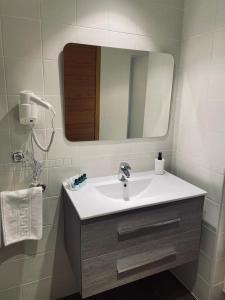 a bathroom with a sink and a mirror at Apartamento Aldeana in Llanes