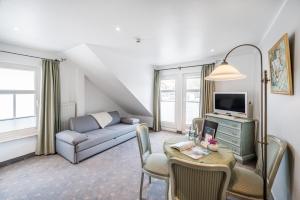 a living room with a couch and a table at Hotel Villa Neander in Binz