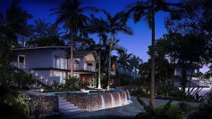 a house with a swimming pool and palm trees at night at Palau Sunrise Sea View Landison Retreat in Melekeok
