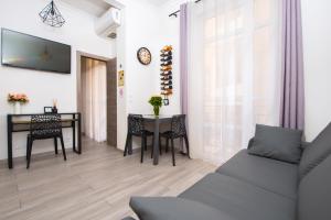 a living room with a table and a couch at Nice Centre Flat - Modern, Quiet and Brand New in Nice