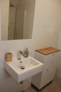 a bathroom with a white sink and a mirror at Park in Sopot