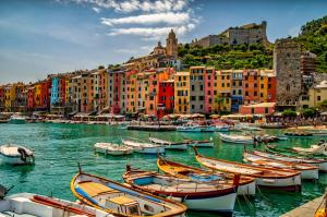 a group of boats docked in a harbor with buildings at Yacht San Lorenzo 22 in La Spezia