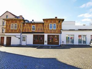 a large building on a cobblestone street at Musashi Apartment 1 in Weimar