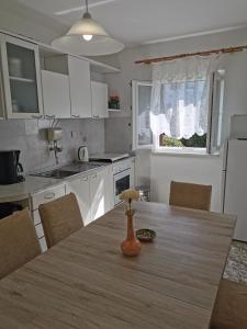 a kitchen with a table with a vase on it at Home Nicole in Bibinje