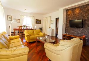 a living room with two couches and a tv at Villa Antonija heated private pool, near Dubrovnik,8plus 2 p ideal for families and groups in Čilipi