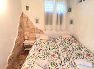 a bedroom with a bed with a floral bedspread at Studio Milla in Split