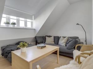 a living room with a couch and a coffee table at Holiday Home Stephie - 1-1km from the sea in NW Jutland by Interhome in Skagen