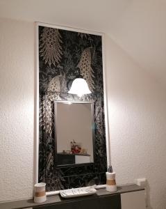 a mirror on a wall in a hotel room at Ferienwohnung Mühlenbachhexe in Lingen
