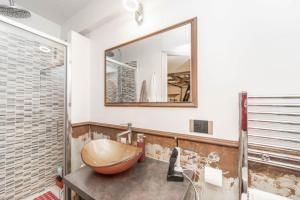 a bathroom with a wooden sink and a mirror at [Loft in centro] Boutique 65 in Turin +14 photos