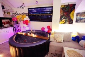 a living room with a large tub in a room with balloons at Art apartman in Kakanj