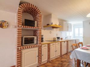 una cocina con un arco en el medio de una habitación en Holiday Home Gîte La Truffière Saintongeaise by Interhome, en Berneuil