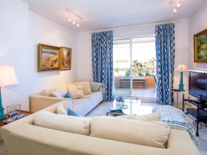 a living room with two couches and a tv at Apartment Jardine de Bolonia Plus by Interhome in Jávea
