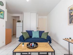salon z niebieską kanapą i stołem w obiekcie Apartment La Louisiane by Interhome w mieście Capbreton