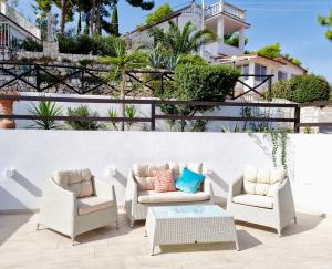 a patio with two chairs and a coffee table at Residence Maresol in Vieste