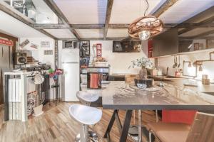 a kitchen with a table and chairs and a refrigerator at [Loft in centro] Boutique 65 in Turin