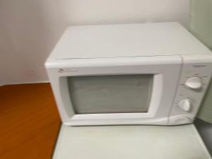 a white microwave oven sitting on top of a counter at ICE APARTMENT in Ljubljana