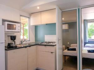 a kitchen with a sink and a stove at Holiday Home Camping Free Beach by Interhome in Marina di Bibbona