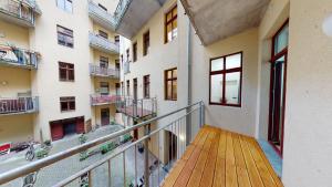 a balcony of an apartment building with a wooden deck at SweetHome - Luxus pur - große Küche, Stellplatz, WiFi in Magdeburg