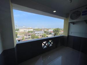 a room with a large window with a view of a city at Sakun Place in Bangna